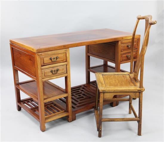 A Chinese elm wood pedestal desk and a hardwood yoke back chair, late 19th century, W.135cm H. 83cm
